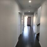 Professionally painted modern residential hallway with crisp white walls and doors completed by S-and-R Painting Group in Pakenham.
