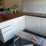 Professionally painted shaker style overhead kitchen cupboards and newly stained timber benchtop by S and R Painting Group in Ashwood and Burwood.