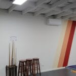 Professionally painted games room with exposed white timber ceiling beams and an accent wall stripe by S and R Painting Group in Mornington and Mount Eliza.