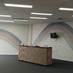 Professionally painted pastel wave mural feature wall in a commercial space by S and R Painting Group in Dandenong and Chadstone.