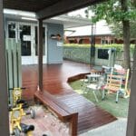 Professionally stained timber deck with a matching wooden bench and freshly painted exterior house wall by S and R Painting Group in Narre Warren and Berwick.